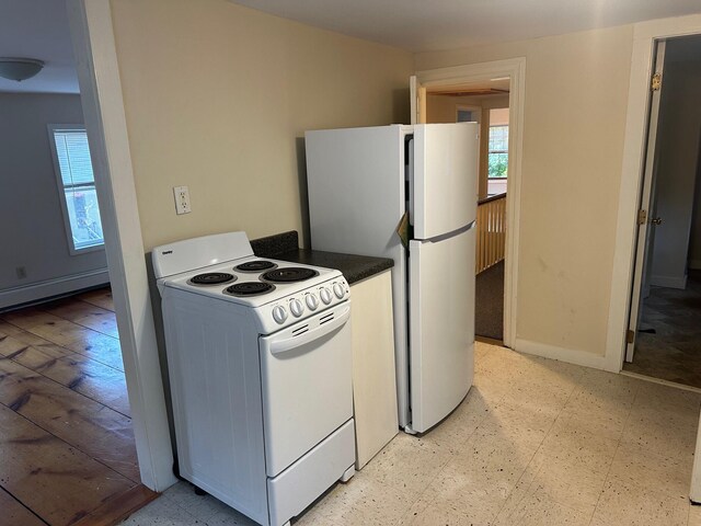 kitchen with white appliances and baseboard heating