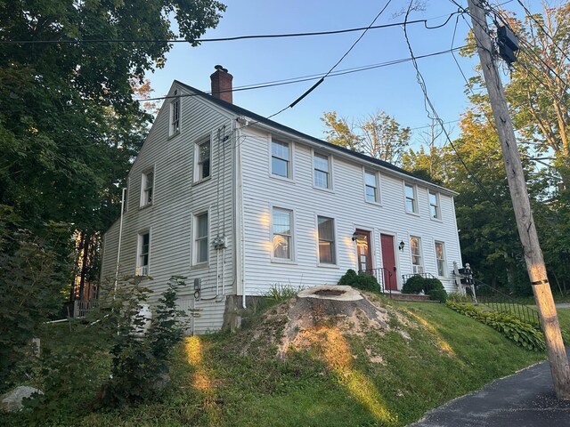 colonial inspired home with a front lawn