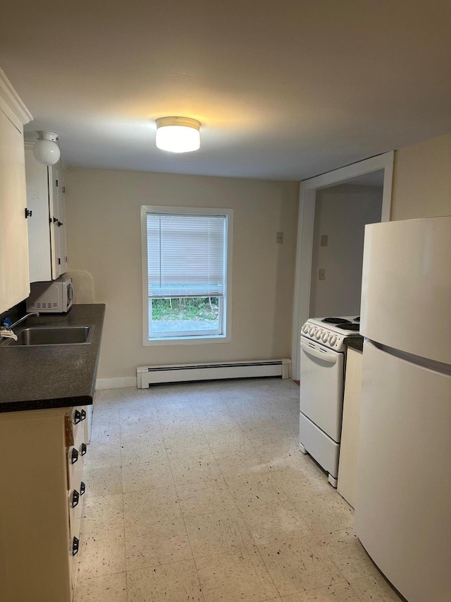 kitchen with a baseboard radiator, white appliances, white cabinetry, light floors, and dark countertops