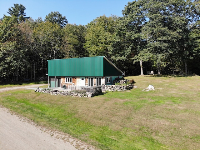 243 Lang Hill Hwy, Brooks, ME 04921 - view of front facade with dirt driveway, a front yard, and metal roof