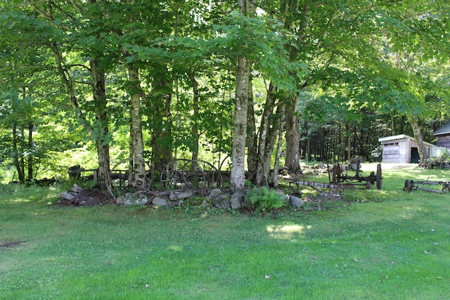 243 Lang Hill Hwy, Brooks, ME 04921 - view of grassy yard featuring a garage
