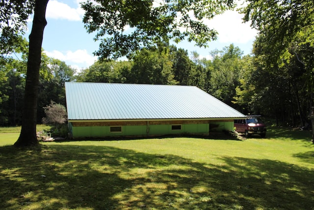 243 Lang Hill Hwy, Brooks, ME 04921 - view of home's exterior featuring a lawn and metal roof