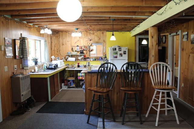243 Lang Hill Hwy, Brooks, ME 04921 - bar area featuring white appliances, a sink, wood walls, heating unit, and pendant lighting