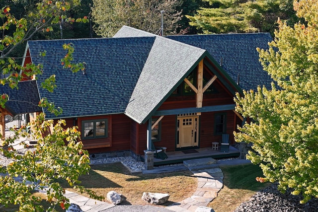 view of front facade featuring a porch and a shingled roof