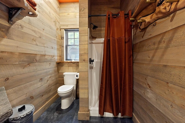 full bathroom featuring wood walls, a stall shower, and toilet