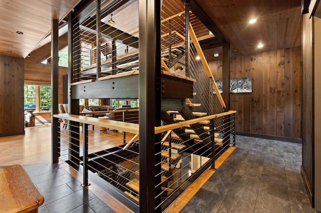 interior space with wooden walls, recessed lighting, baseboards, and wood ceiling