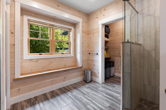 interior space featuring wooden walls and baseboards