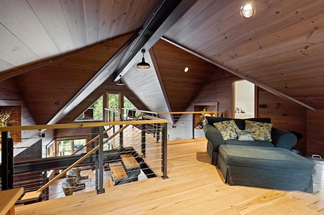 additional living space featuring lofted ceiling with beams, wooden ceiling, and wood walls