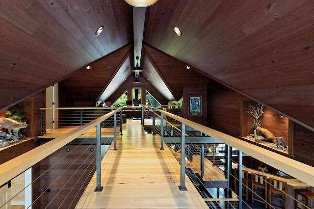interior space with wooden ceiling, wood finished floors, wood walls, and lofted ceiling