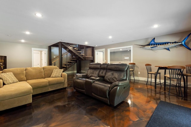 living room featuring baseboards, stairway, and recessed lighting