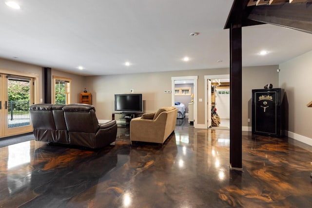 living area featuring recessed lighting and baseboards