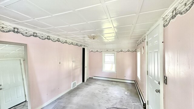 spare room featuring concrete floors and a baseboard radiator