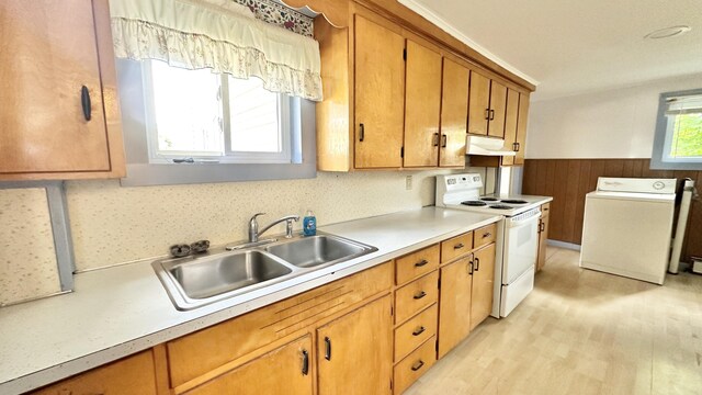 kitchen featuring light wood-type flooring, a healthy amount of sunlight, white range with electric stovetop, and sink