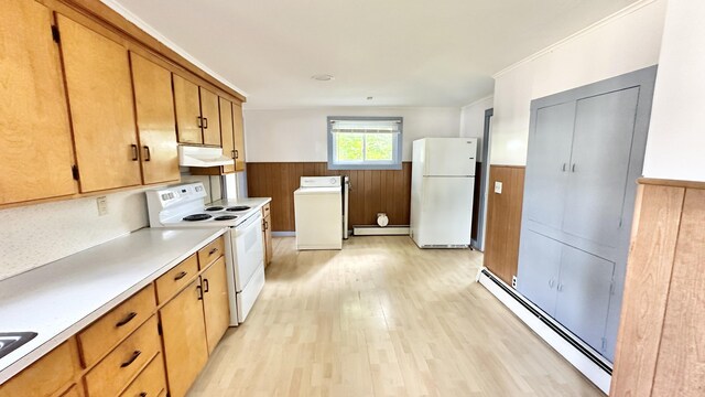 kitchen featuring wooden walls, a baseboard heating unit, white appliances, light hardwood / wood-style floors, and washer / clothes dryer