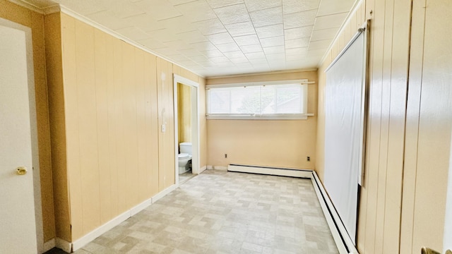 120 Knox St, Millinocket, ME 04462 - empty room featuring wooden walls, baseboards, and a baseboard radiator