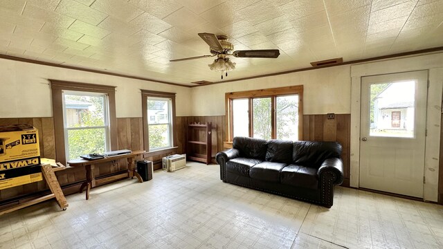 living room with wood walls and ceiling fan