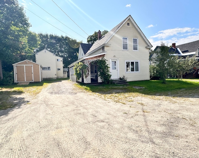 view of front of home featuring a storage shed