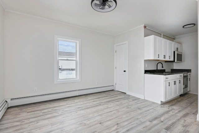 kitchen with a baseboard radiator, sink, white cabinetry, and light hardwood / wood-style flooring