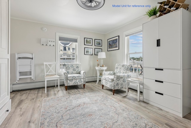 living area with baseboard heating, crown molding, and light hardwood / wood-style flooring