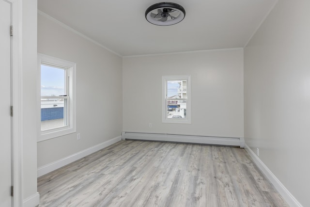 empty room with ornamental molding, a baseboard radiator, baseboards, and wood finished floors