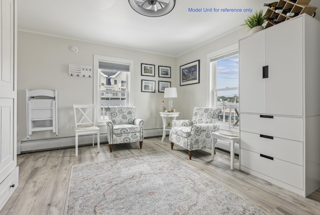 sitting room with ornamental molding, baseboard heating, and wood finished floors