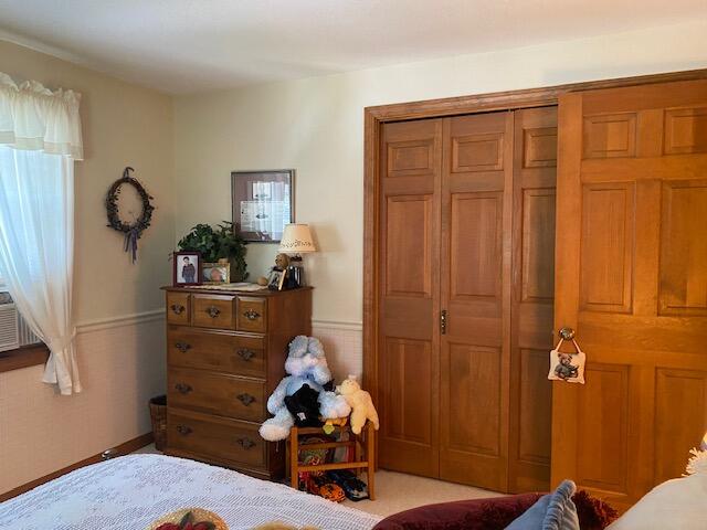 bedroom featuring light colored carpet