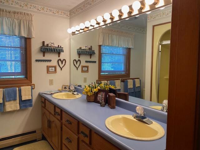 bathroom with a shower with door, baseboard heating, and vanity