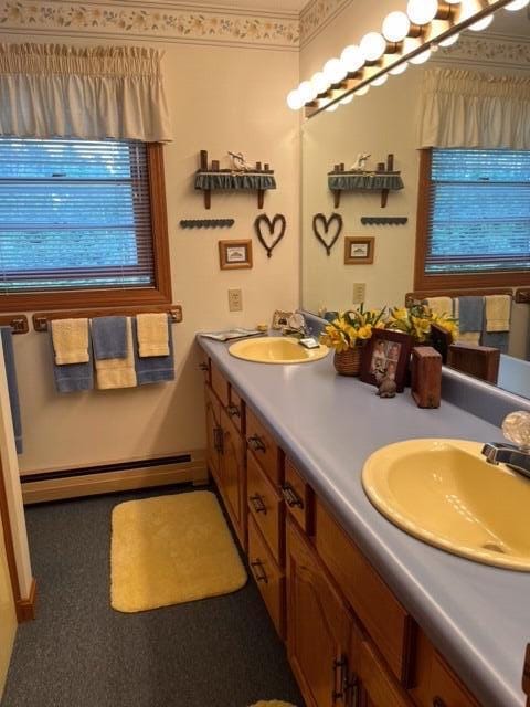 bathroom with vanity and baseboard heating