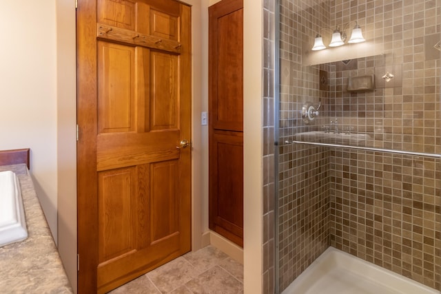 bathroom featuring tile patterned floors and a tile shower
