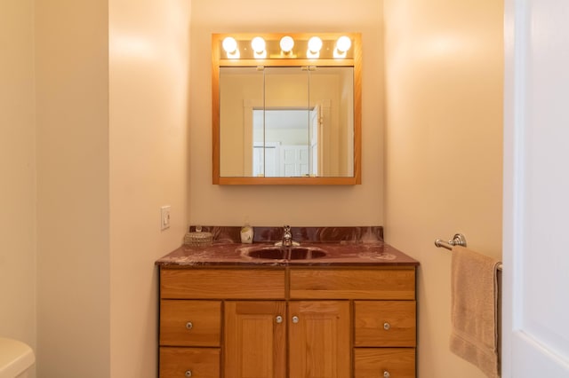 bathroom featuring toilet and vanity