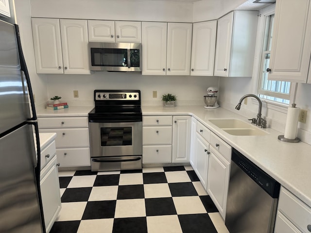 kitchen featuring sink, stainless steel appliances, and white cabinets