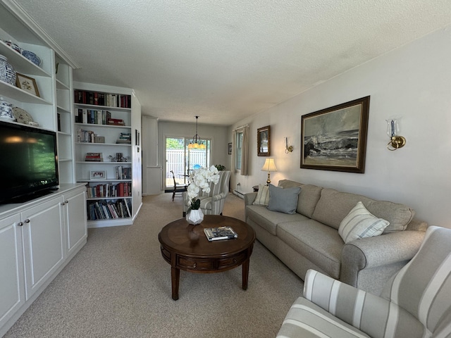 living room with light colored carpet and a textured ceiling