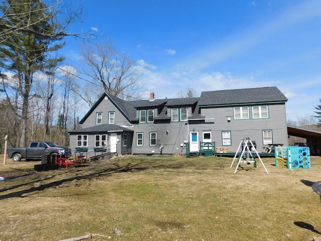 back of house featuring a yard