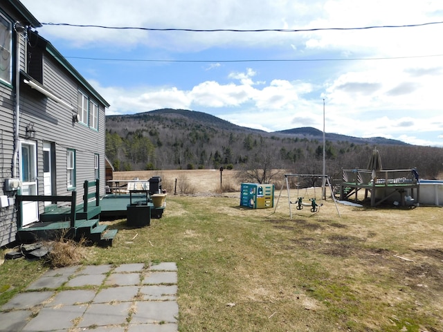 view of yard featuring a deck with mountain view