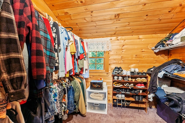 walk in closet with lofted ceiling and carpet