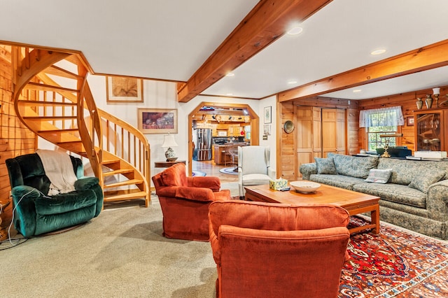 carpeted living room with beam ceiling