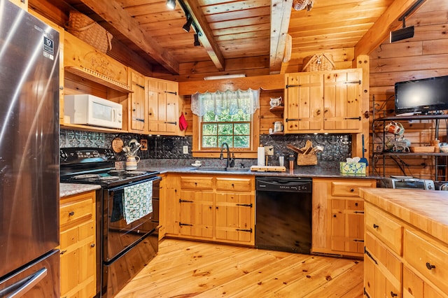 kitchen featuring light hardwood / wood-style flooring, rail lighting, black appliances, sink, and beam ceiling