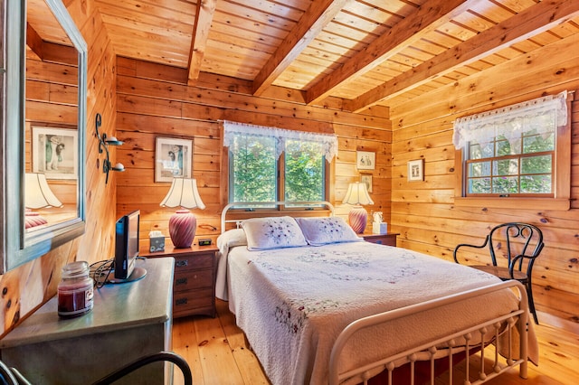 bedroom with multiple windows, light hardwood / wood-style floors, wooden ceiling, and beam ceiling