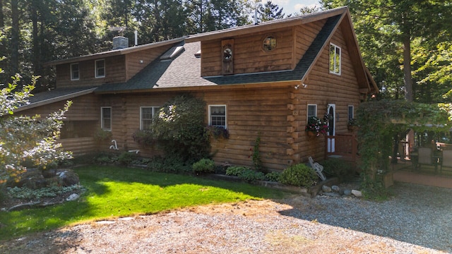 view of side of home with a yard