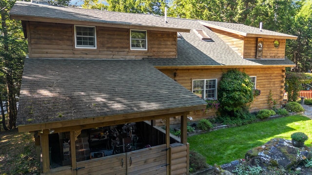 rear view of property with a yard