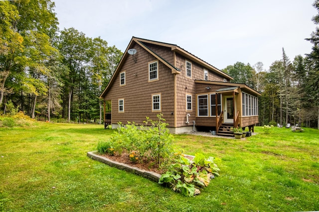 rear view of property featuring a yard