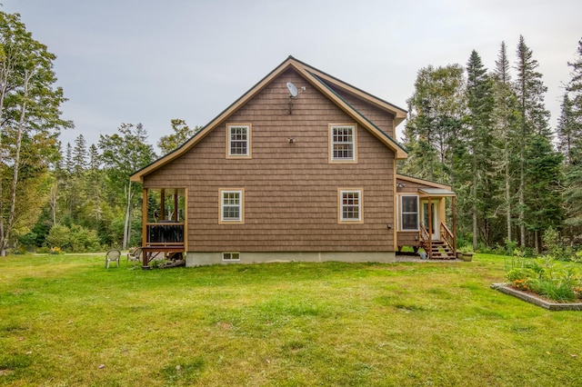 back of property featuring a lawn