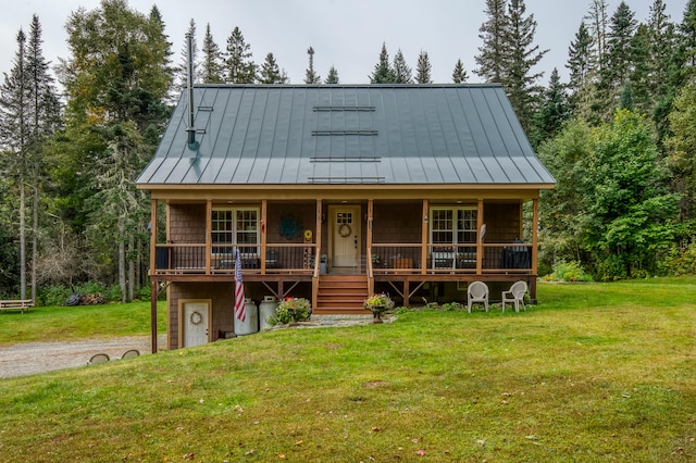 view of front of house featuring a garage, a front lawn, and covered porch