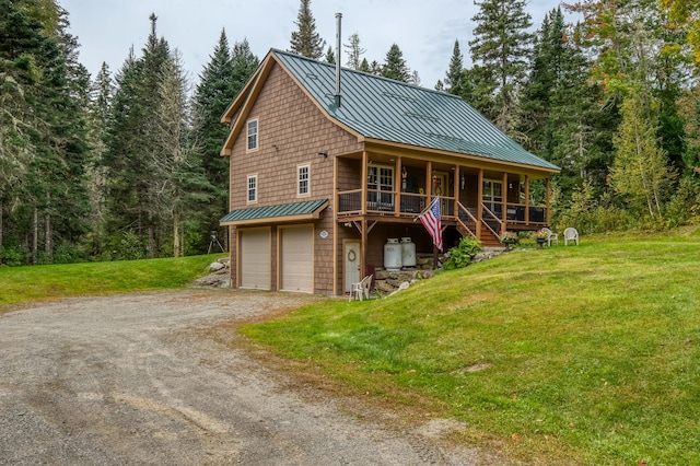 log-style house featuring a garage, a front lawn, and covered porch