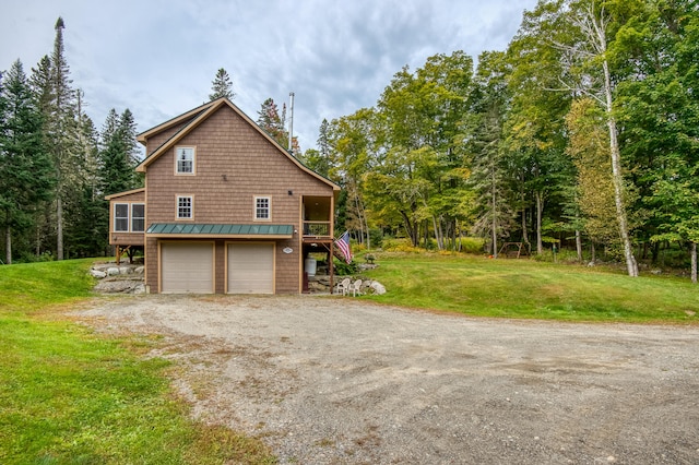 view of property exterior featuring a yard and a garage