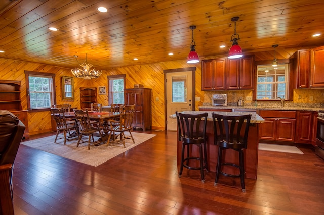 dining area with wooden ceiling, wood walls, and dark hardwood / wood-style flooring