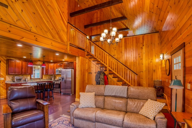 living room with wood ceiling, dark wood-type flooring, high vaulted ceiling, wood walls, and a chandelier