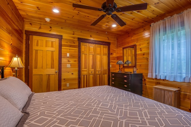 bedroom featuring radiator, wood walls, a closet, and ceiling fan