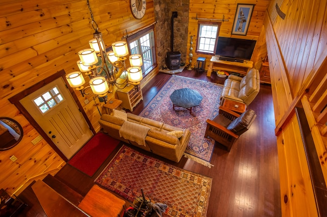 living room featuring a high ceiling, wood walls, and hardwood / wood-style flooring