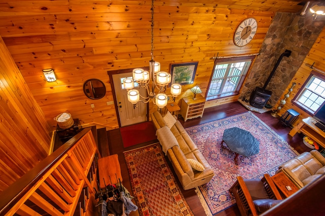 interior space featuring a healthy amount of sunlight, wooden walls, and dark hardwood / wood-style floors